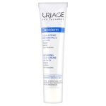 Un tube blanc et bleu de Cica-Crème Réparatrice Uriage Bariéderm au Cu-Zn. Le packaging met en avant ses propriétés cicatrisantes et apaisantes pour les peaux fragiles et irritées. Le tube est petit, adapté à une application sur le visage et le corps et hypoallergénique.