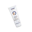 Un tube blanc de crème Genskin, étiqueté « 250 g » à la base. Le produit comporte un logo circulaire bleu avec un triangle orange à l'intérieur et un texte en espagnol le décrivant comme une crème apaisante pour les problèmes causés par l'incontinence.