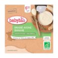 Une image d'un produit alimentaire pour bébé étiqueté « babybio Brassé Avoine Banane ». L'étiquette mentionne également "Boisson d'avoine - 100% végétal", "6 mois et +", "Fabriqué en France" et "Agriculture Biologique". Un récipient contenant de la nourriture avec une cuillère en bois est partiellement visible.