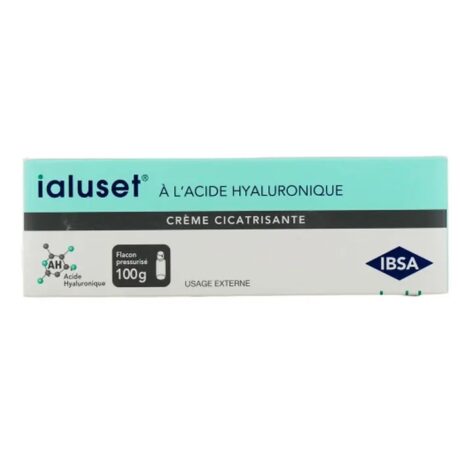 Une boîte de produit présente IALUSET Creme Cicatrisante A l’acide Hyaluronique 100g, une crème cicatrisante à l’acide hyaluronique. L'emballage est principalement blanc avec une bande bleu sarcelle et comprend du texte en français. La boîte indique que la crème est à usage externe, est présentée dans un flacon pressurisé et a un volume de 100 g.