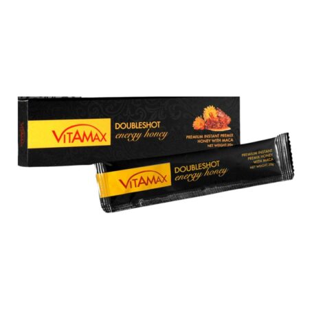 une boîte noire étiquetée « miel énergétique vitamax doubleshot » est présentée à côté d'un sachet noir assorti portant la même étiquette et des accents orange. l'emballage mentionne également « miel énergétique instantané de qualité supérieure avec maca » et un poids net de 12 grammes.