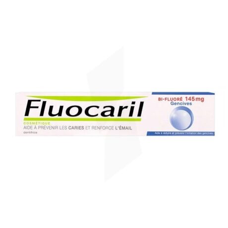 une boîte de dentifrice fluocaril avec un texte vert et rouge. il met en avant la prévention des caries et le renforcement de l'émail. le produit est étiqueté comme "bi fluoré 145 mg" et mentionne une aide à la protection des gencives.
