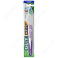 une brosse à dents emballée avec un manche violet et des poils blancs, étiquetée « gum activita ». l'emballage est principalement vert et blanc avec une section transparente montrant la brosse à dents.