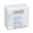 boîte blanche de pain dermatologique surgras uriage, 100 g, pour peaux sensibles. l'emballage est orné de points bleus et d'un texte en français et en anglais décrivant ses qualités nettoyantes, nourrissantes et protectrices.