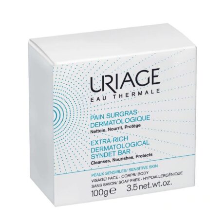 boîte blanche de pain dermatologique surgras uriage, 100 g, pour peaux sensibles. l'emballage est orné de points bleus et d'un texte en français et en anglais décrivant ses qualités nettoyantes, nourrissantes et protectrices.