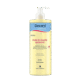 flacon jaune d'huile de douche apaisante dexeryl essentiel avec pompe. l'étiquette met en avant sa formule douce et apaisante, adaptée aux peaux sèches. le texte en français indique une utilisation précoce dès la naissance et mentionne les propriétés dermo cosmétiques.