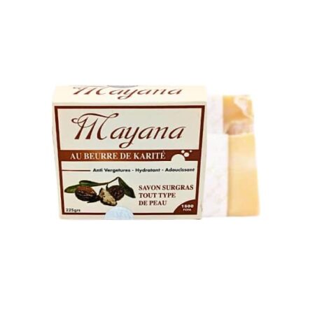 une boîte de savon mayana au beurre de karité au beurre de karité, étiqueté pour tous les types de peau. la boîte est blanche et marron avec un texte en français et une image de noix de karité. la barre de savon est partiellement visible à côté de la boîte.