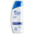 une bouteille blanche de shampooing antipelliculaire head & shoulders classic clean avec un bouchon bleu, avec une marque bleue, des bulles et un texte en allemand sur l'étiquette.